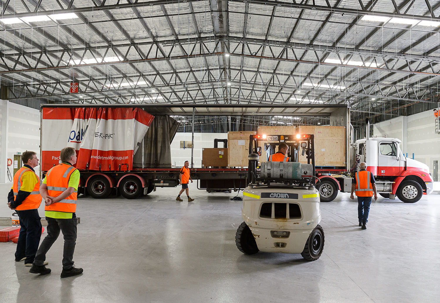 Image of manufacturing facility and machines arriving