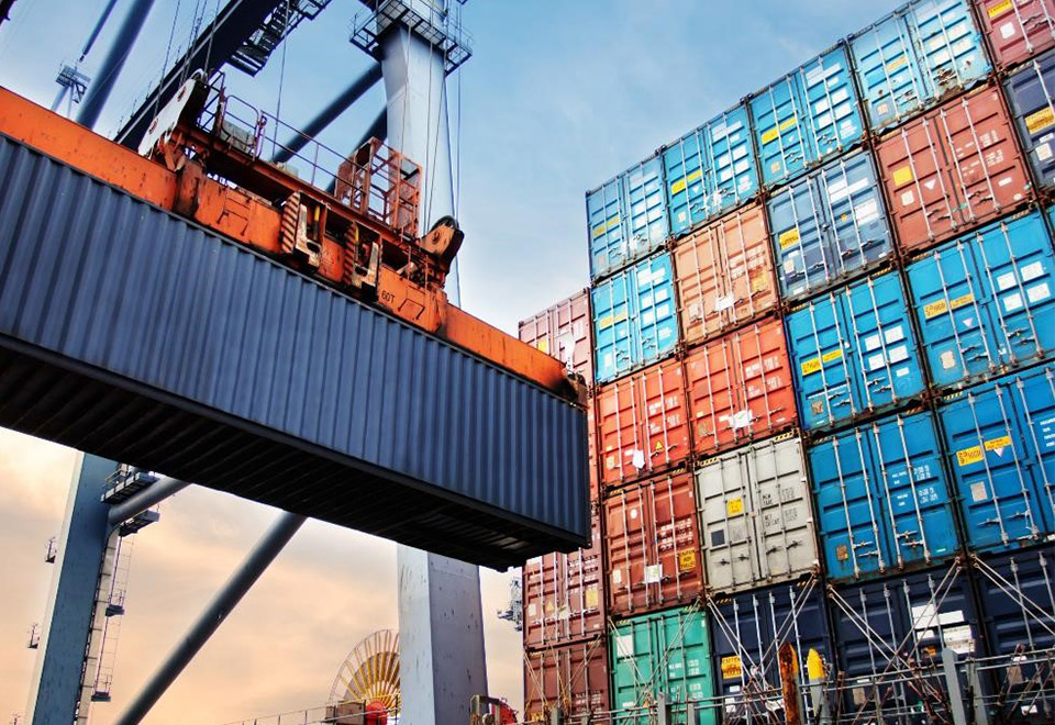 Freight containers being stacked by a crane