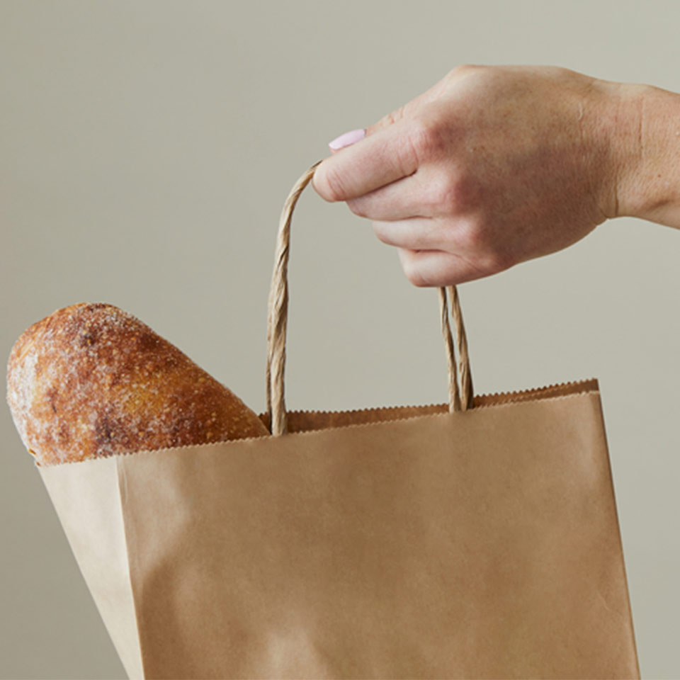 Image of person carrying a recyclable paper bag