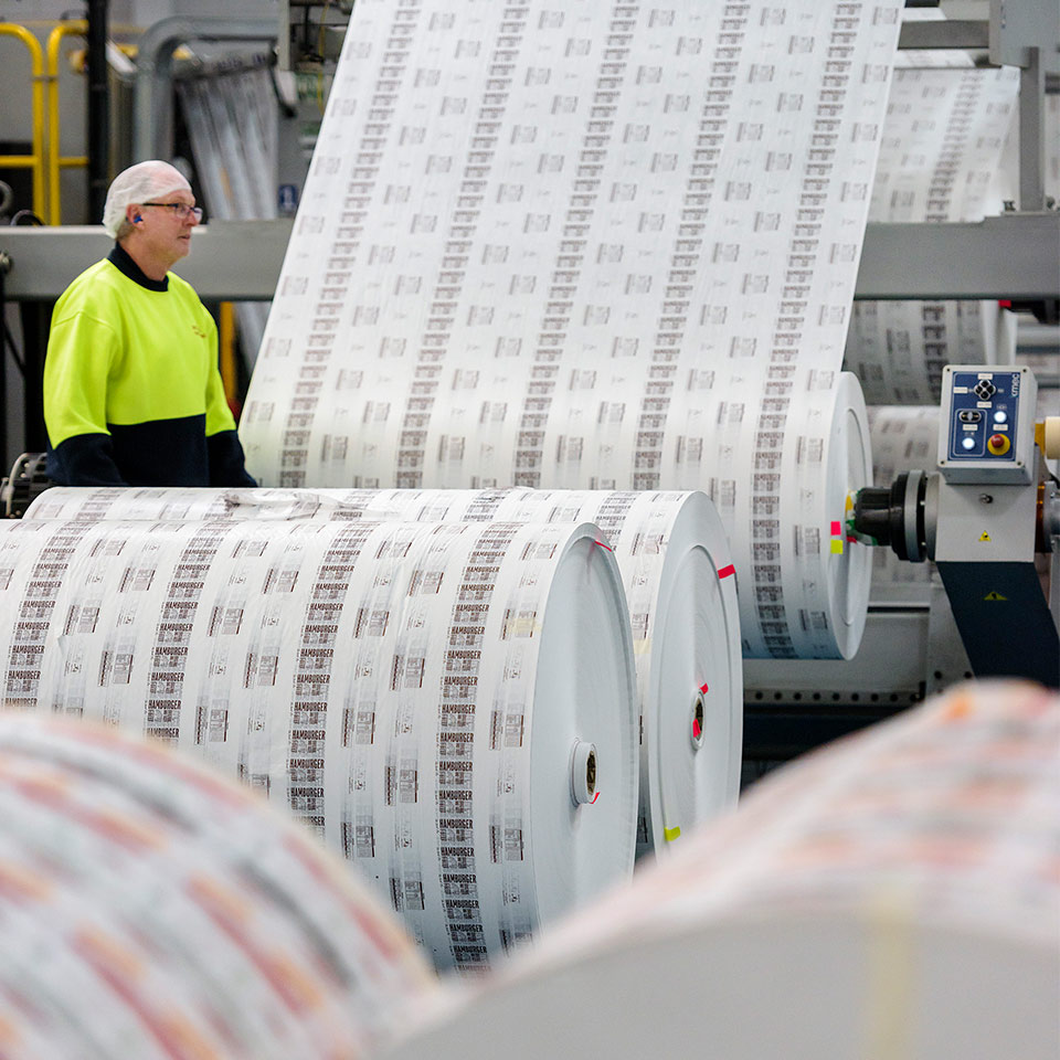 Image of Detpak facility and a roll of product on a machine